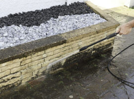 man cleaning wall with high pressure cleaner in close... man cleaning wall with high pressure cleaner in close...
